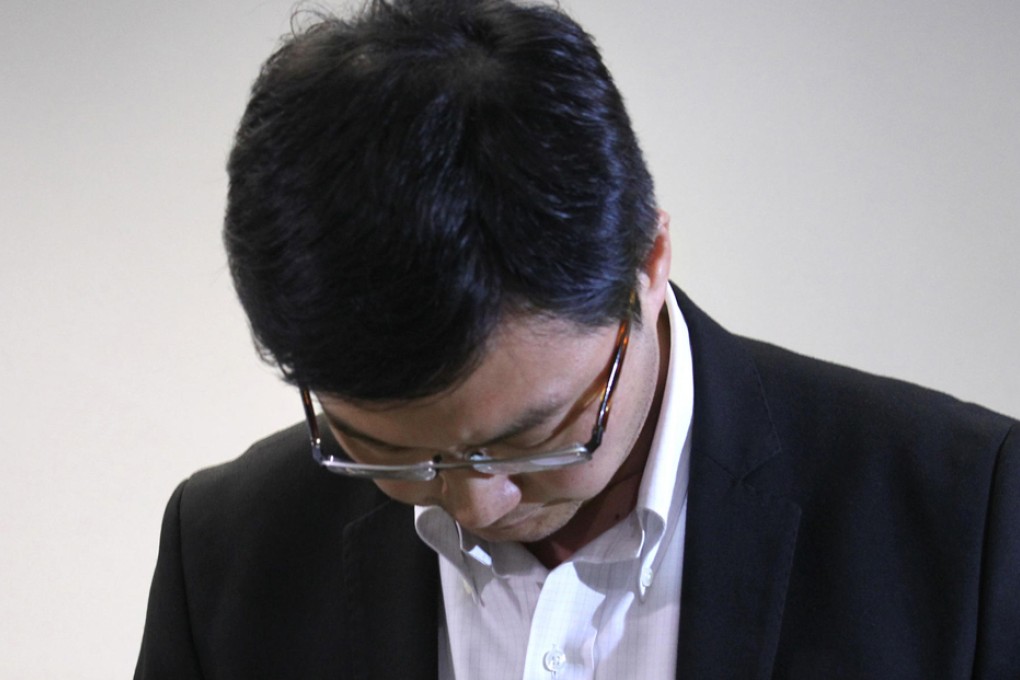 Henry Ho bows his head as he quits his job. Photo: Dickson Lee