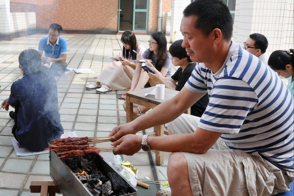 Zhu Changzhen shows his grilling skills, honed over many years in a night market before he became a journalist. Photo: SCMP