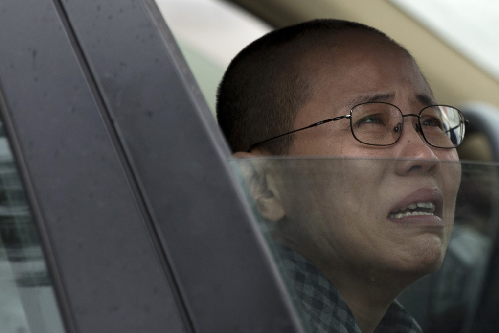Liu Xia, wife of imprisoned Nobel Peace Prize winner Liu Xiaobo, cries in a car outside Huairou Detention Center in Beijing where her brother Liu Hui has been jailed. Photo: AP