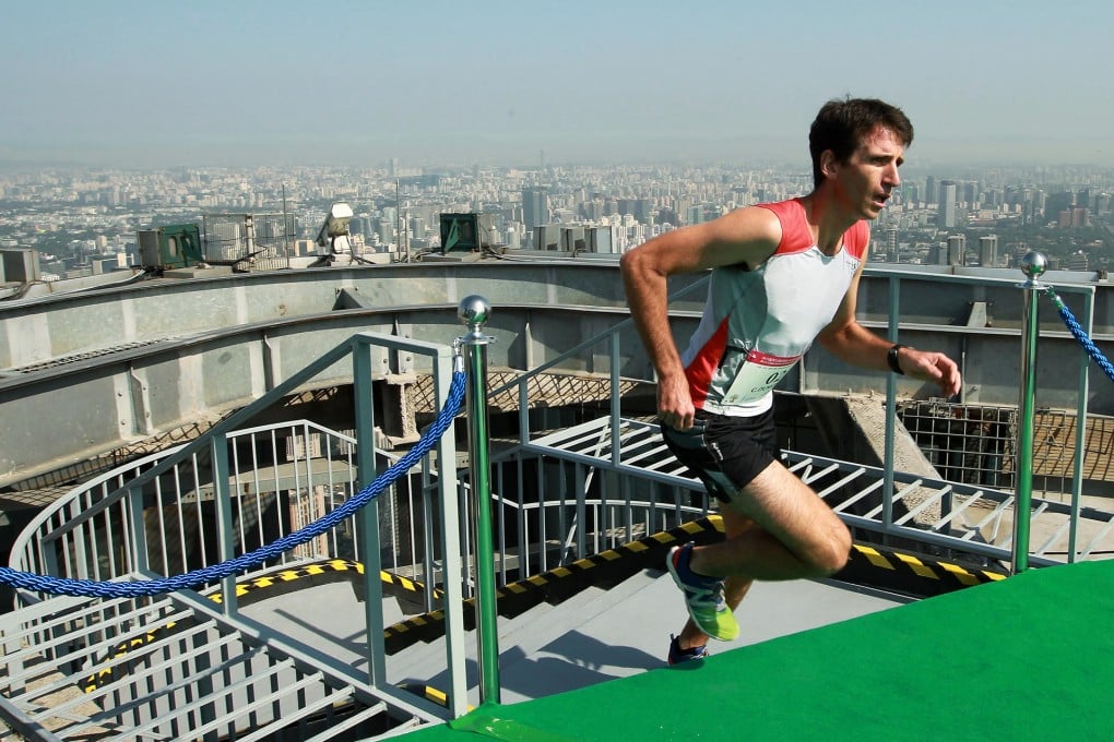 Clement Dumont strides to the finish line after climbing the 2,041 steps in Beijing's tallest building. Photo: Simon Song