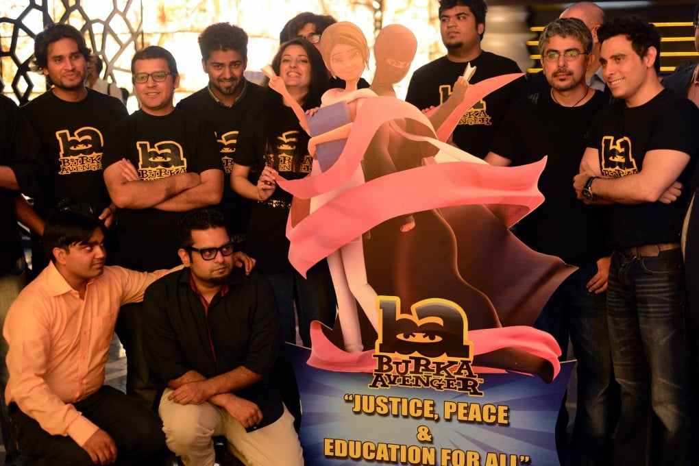 Aaron Haroon Rashid (R) poses with his team at the press presentation of cartoon show Burka Avenger in Rawalpindi. Photo: AFP