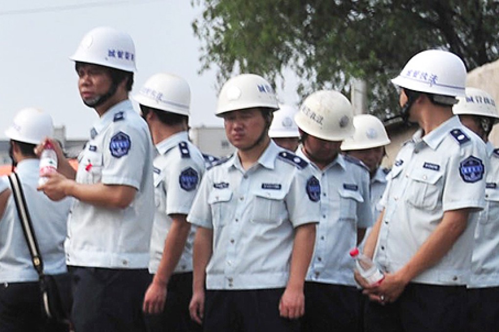 Chengguan, who are tasked with enforcing non-criminal regulations in towns and cities, have long been accused of abusing their powers. Photo: EPA