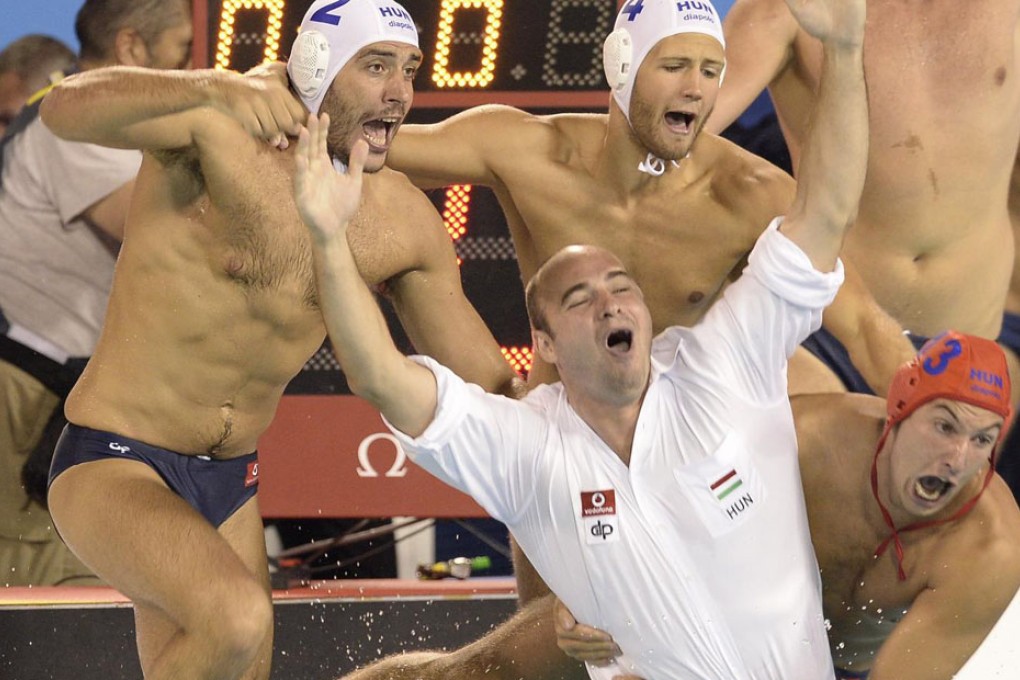 Hungary's players and coaches celebrate their tense victory in the men's water polo final at world titles. Photo: AP