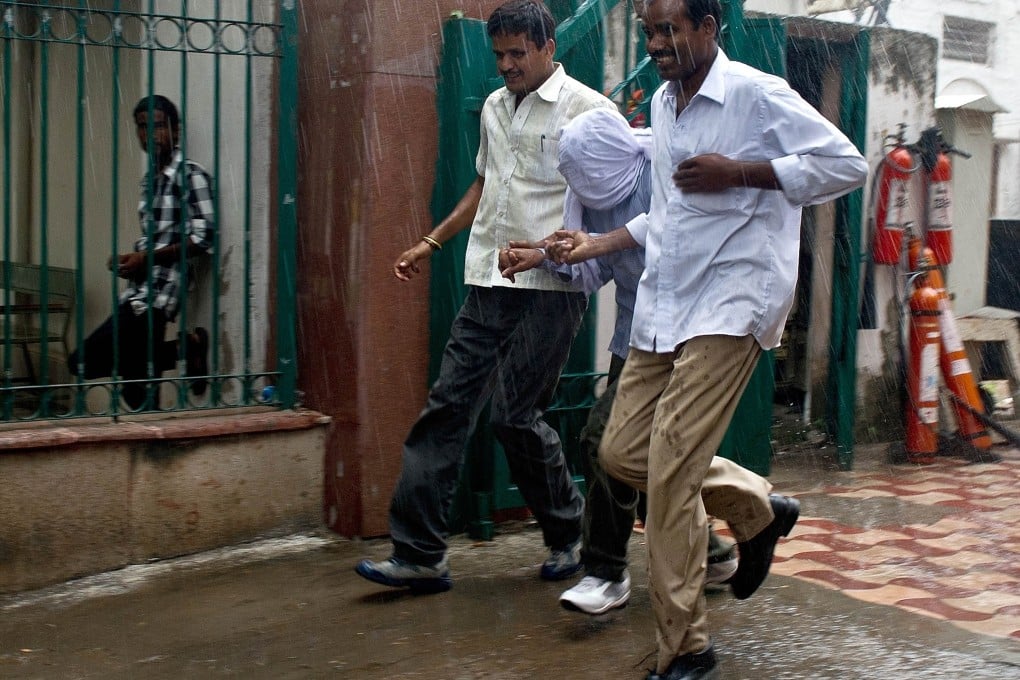 Indian policemen escort the juvenile accused in the gang-rape of a student outside the juvenile court in New Delhi. Photo: AFP