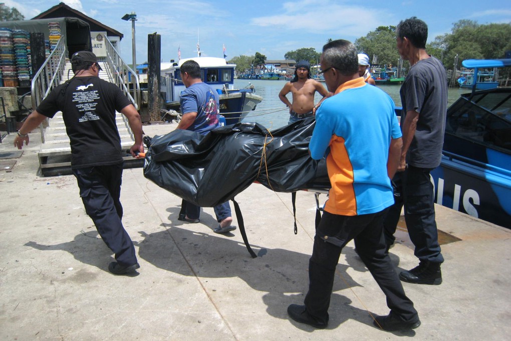 Maritime officials in Johor state transporting three victims found at sea. Photo: AFP