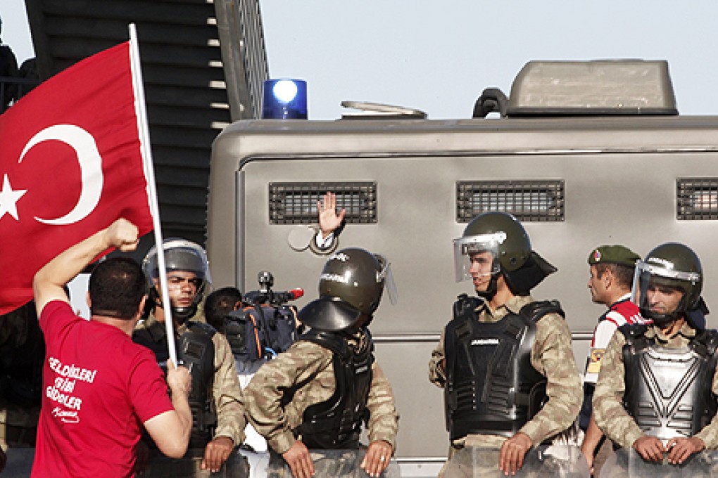 An unidentified defendant waves out of a van as he's driven to a courthouse in Silivri, Turkey, on Monday. Photo: Reuters