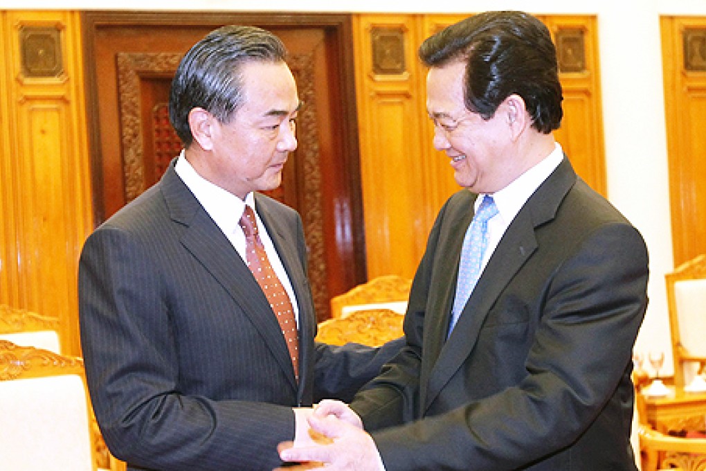 Visiting Chinese Foreign Minister Wang Yi (left) shakes hands with Vietnamese Prime Minister Nguyen Tan Dung in Hanoi on Monday. Photo: AFP