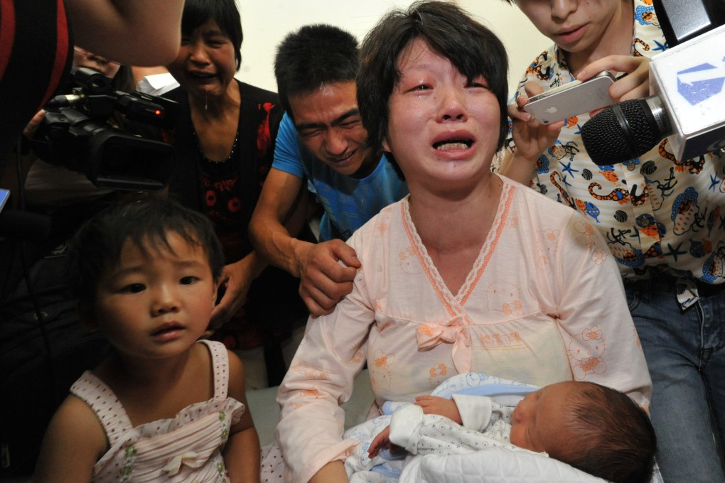 The baby who was allegedly sold to human traffickers by an obstetrician about 20 days ago was returned to his parents, Lai Guofeng and his wife, on Monday. Photo: Xinhua