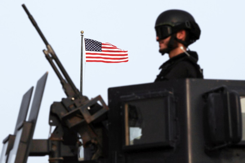 A Bahraini armoured personnel vehicle reinforces US Embassy security outside a gate to the embassy building in Manama, Bahrain.Photo: AP