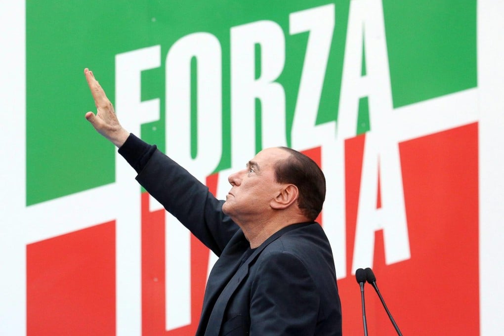 Ex-prime minister Silvio Berlusconi greets supporters at the rally in Rome, where he reaffirmed his support for the coalition.Photo: EPA