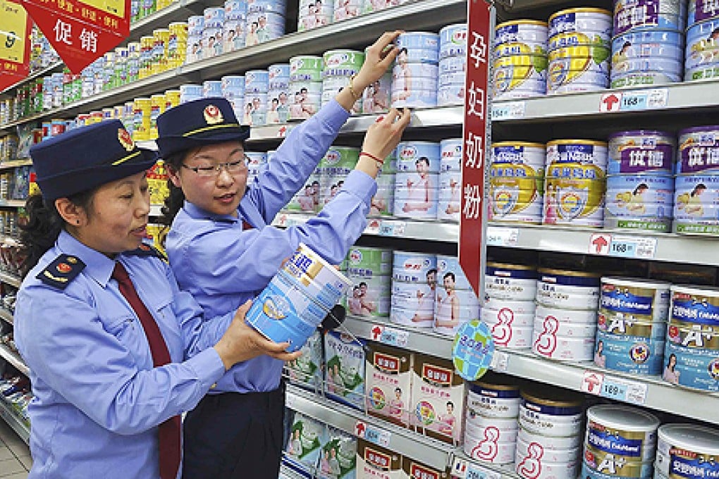 Chinese commercial law enforcement personnel inspect milk powder products at a supermarket in Lianyungang, Jiangsu province on Tuesday. Photo: Reuters