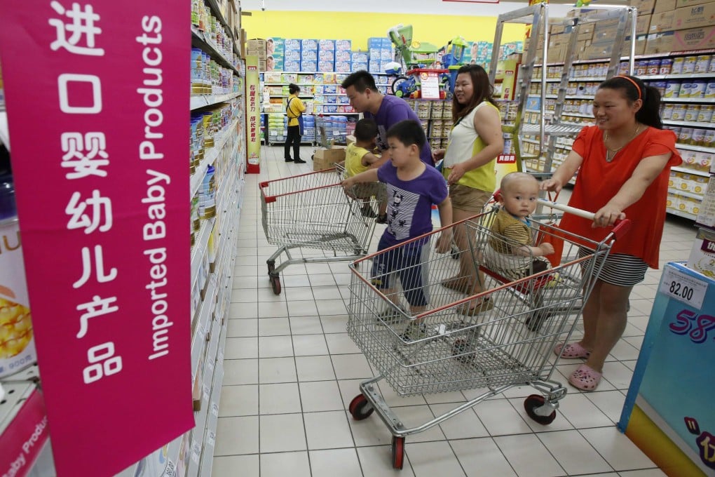 Chinese shoppers look over baby formula products. Baby formula safety is a sensitive issue in China, after milk tainted with the chemical melamine left six children dead and sickened more than 300,000 in 2008. Photo: Reuters