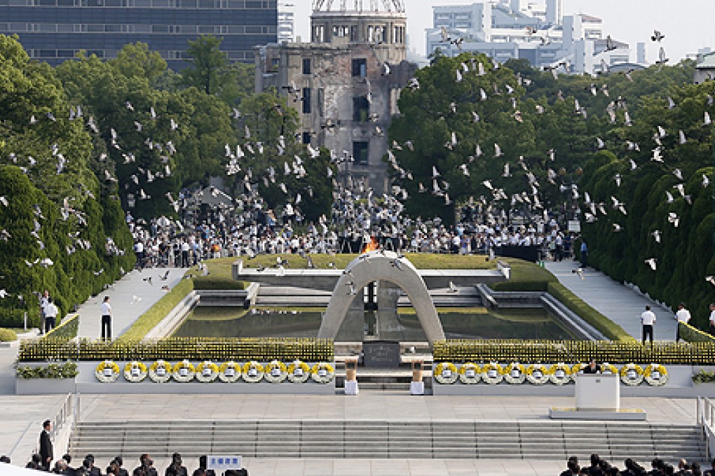 Doves are released over the Hiroshima Peace Memorial Park in Hiroshima on Tuesday. Photo: EPA