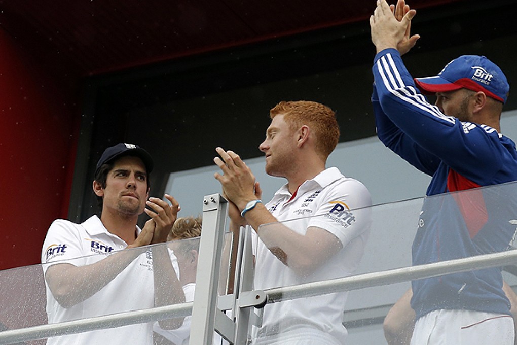 England's Cook, Bairstow and Prior applaud the crowd from their balcony after play was abandoned and the match drawn on the final day of the third Ashes test at Old Trafford cricket ground in Manchester. Photo: Reuters