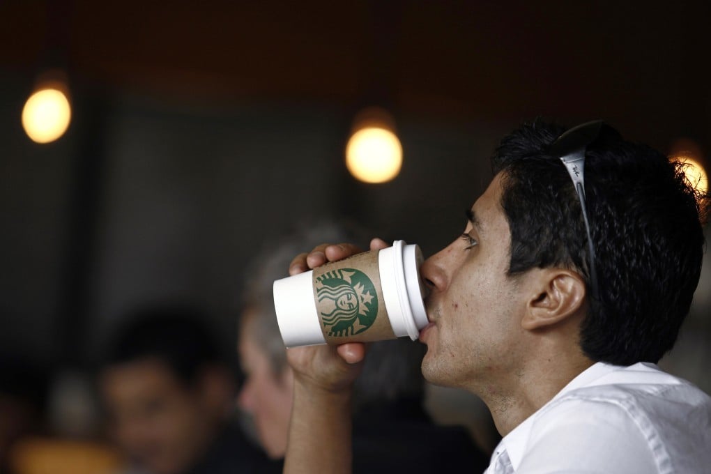 A customer drinks a cup of Starbucks coffee in San Jose. Photo: Reuters