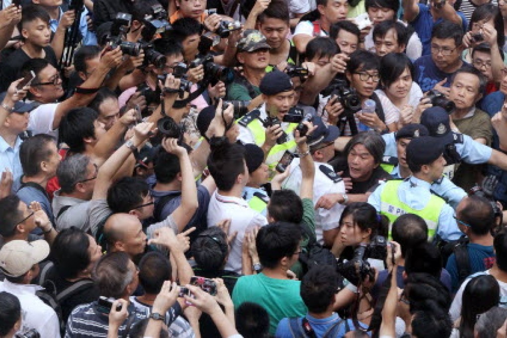 Legislator Leung Kwok-hung (centre) and supporters of primary school teacher clash with opponents while hundreds of people attended a rally in Mong Kok. Photo: David Wong