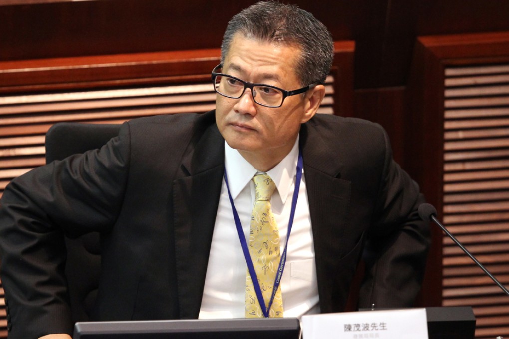 Development minister Paul Chan has defied calls to step down over a conflict of interest row involving his family. Photo: Edward Wong