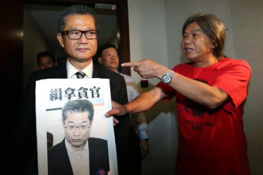 Legislator Leung Kwok-hung protests to Secretary for Development Paul Chan Mo-po. Photo: Sam Tsang