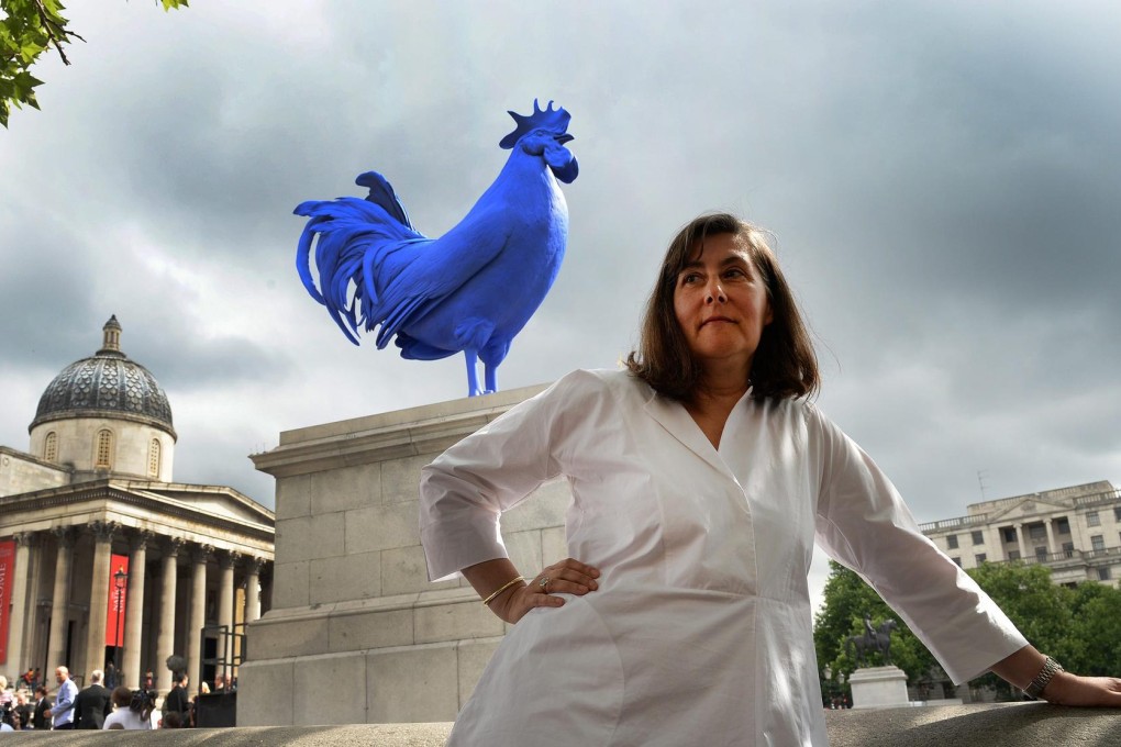 German sculptor Katharina Fritsch stands before her piece Hahn/Cock after its unveiling at Trafalgar Square's Fourth Plinth. Photos: EPA, Corbis