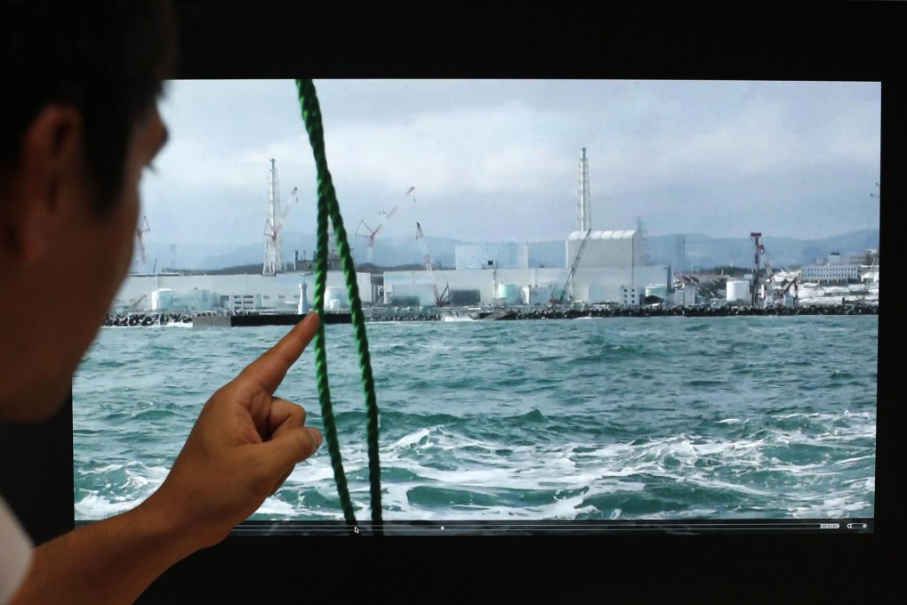 An acituteademic from the University of Tokyo's Inst of Industrial Science Underwater Technology Research Centre examines a video of the Fukushima Daiichi plant, which is still poisoning the ocean. Photo: Reuters