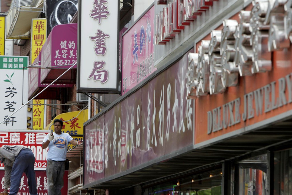 Store signs in the Flushing neighbourhood of New York. Photo: AP