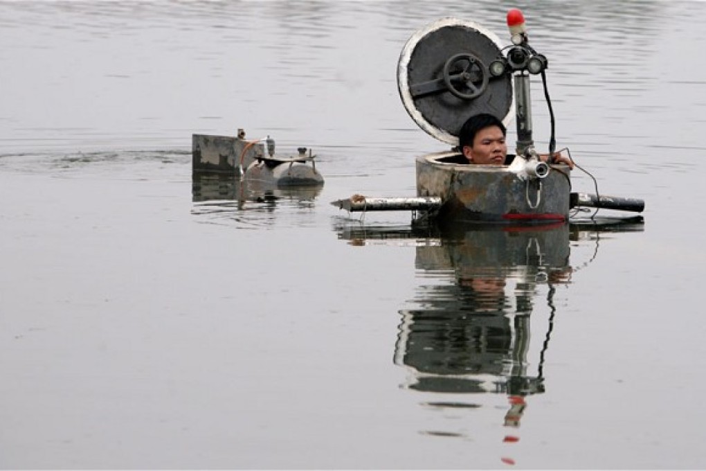 Tao and his home-made underwater craft. Photo: Reuters