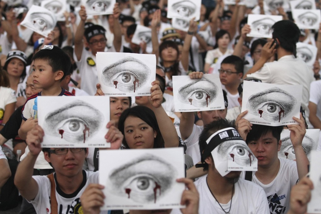 People, holding placards of a bleeding eye, take part in a demonstration in front of the Presidential Office in Taipei. Taiwan’s army chief is seeking to quit after the death of a young soldier. Photo: Reuters