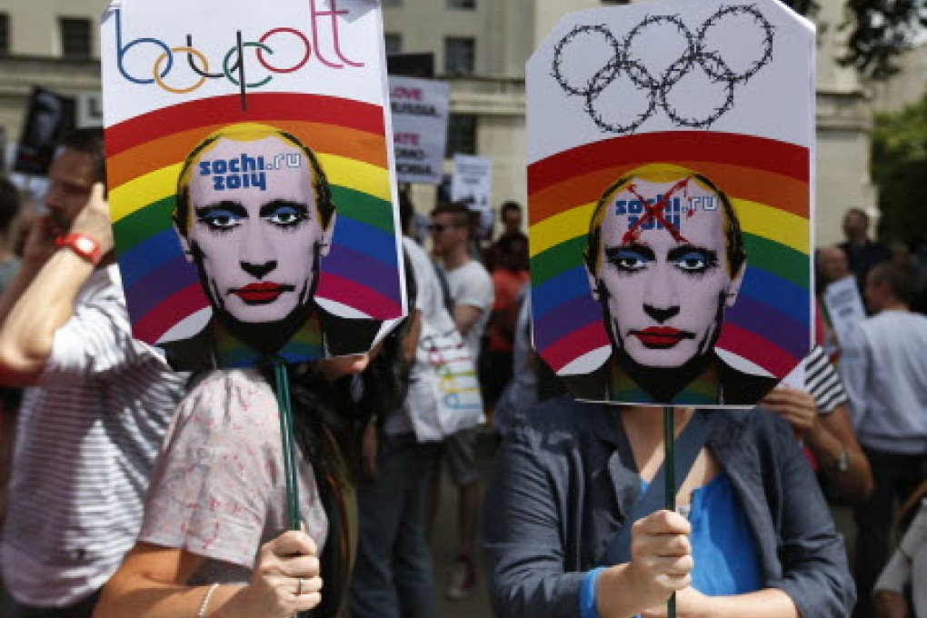 Activists in London holding placards depicting Russian President Vladimir Putin, participate at a protest against Russia's new law on gays. Photo: AP