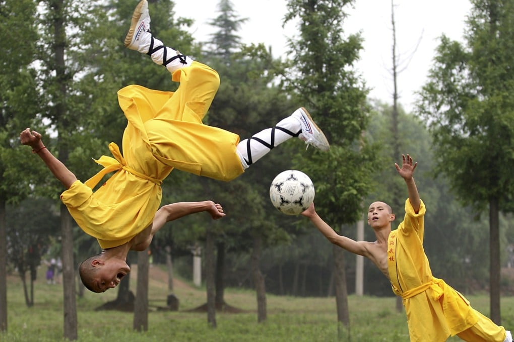 Shaolin students show their skills as they play soccer at Tagou Wushu School in Dengfeng, Henan, in 2010. Photo: AP