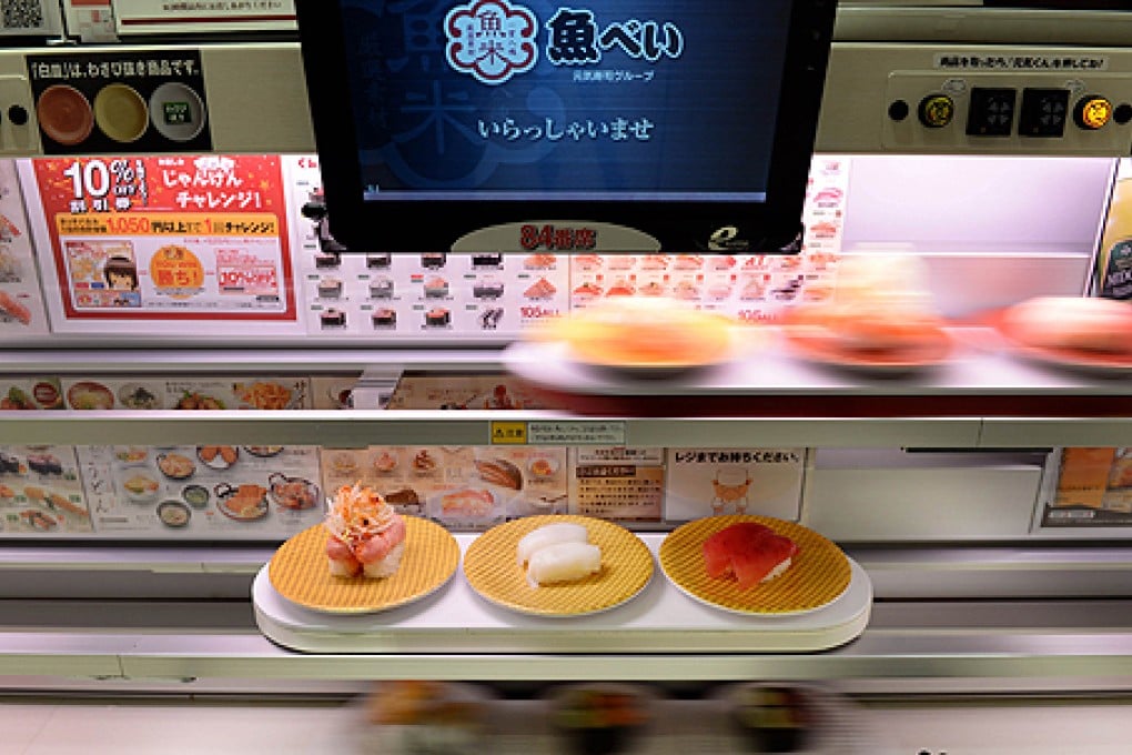 Three decks of "high-speed" lanes transport sushi dishes for customers at the Uobei restaurant in Tokyo. Photo: AFP