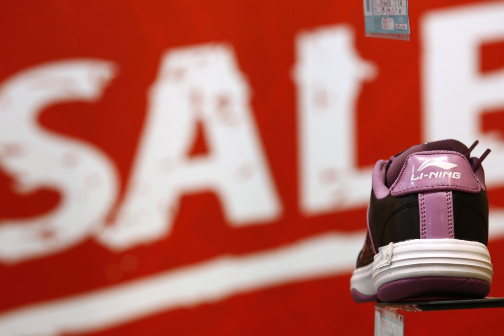 A Li Ning shoe is displayed in front of a promotional board at a shop in Beijing. Photo: Reuters