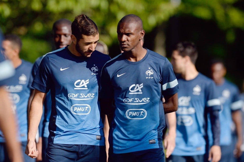 Eric Abidal (right) and France teammate Karim Benzema take part in a training session. Photo: AFP