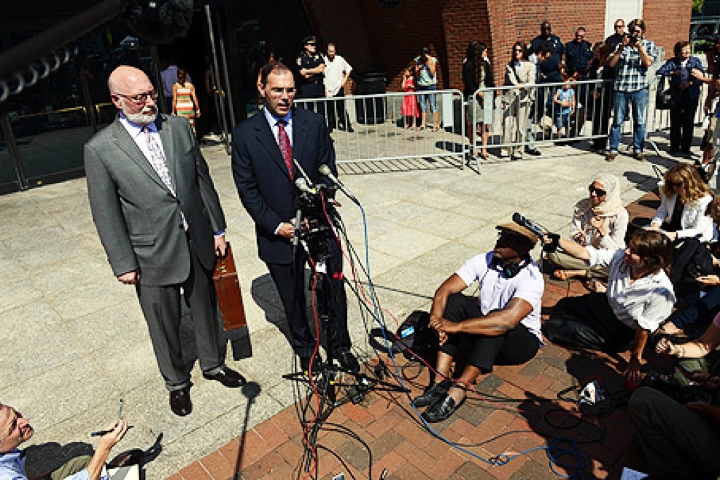 Defence lawyers JW Carney (left) and Hank Brennan speak to reporters outside the courthouse after a guilty verdict against their client James "Whitey" Bulger. Photo: AFP