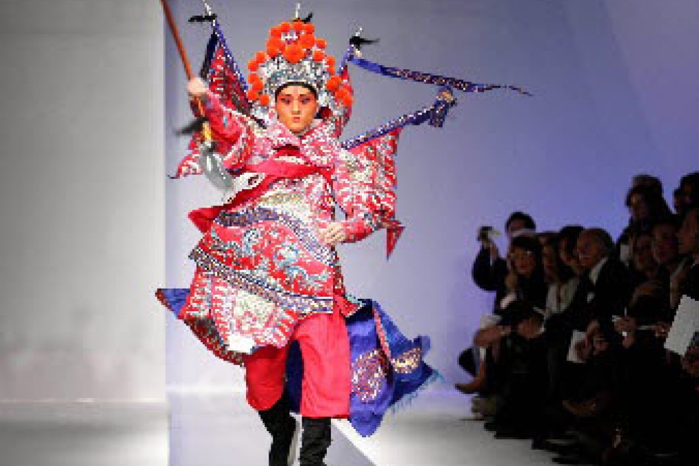 An actor comes on in full costume of Beijing Opera during a men's wear show by Chinese brand Lilang in Milan. Photo: Xinhua