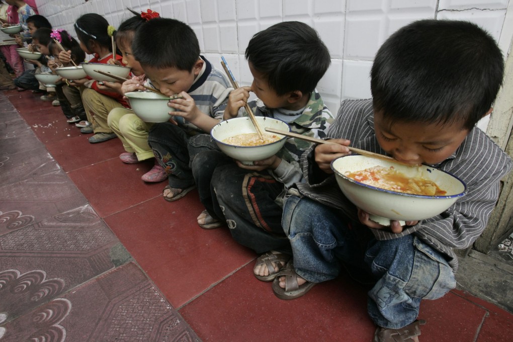 Pupils at a school on the outskirts of Chongqing municipality eat lunch. Photo: Reuters