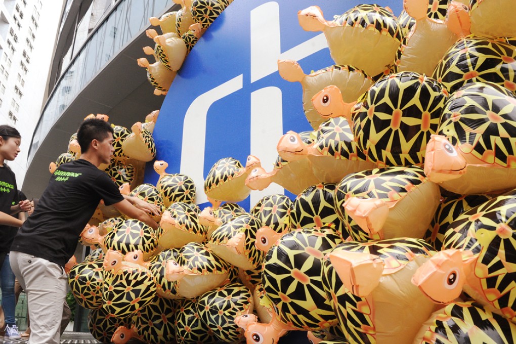 Members of Greenpeace set turtle balloons outside CLP headquarters in Hung Hom during protest to request energy saving.