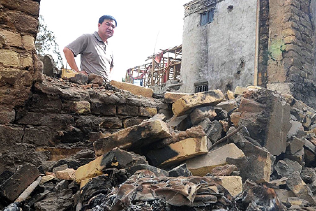 A man stands at the site of a violent clash in Kashgar in April. Photo: AP