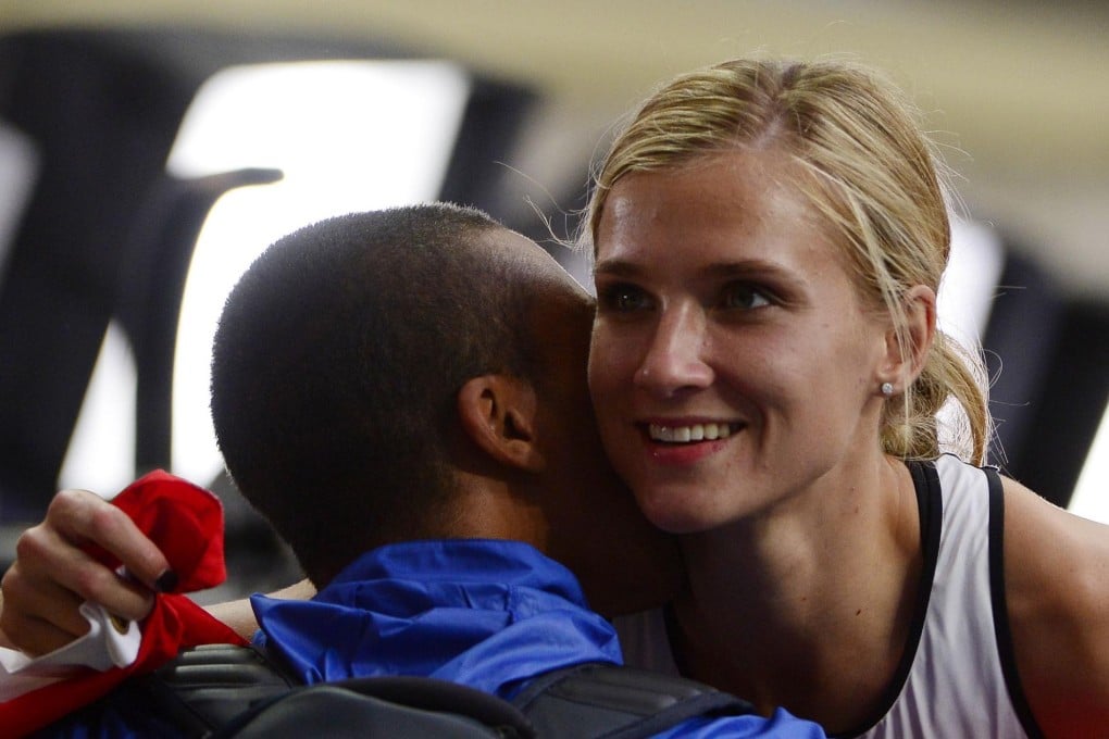 Brianne Theisen Eaton hugs her husband, Ashton Eaton, after she won the silver medal in the women's heptathlon. Photo: AFP