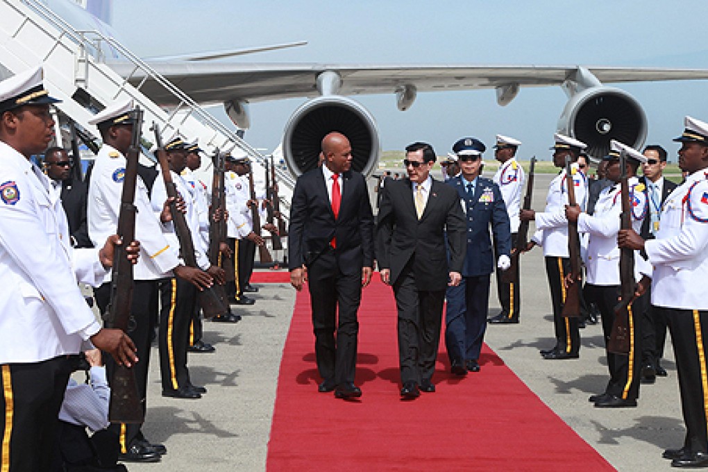 Taiwan's President Ma Ying-jeou (centre) arrives in Port-au-Prince and is welcomed by his Haitian counterpart Michel Martelly. Photo: EPA