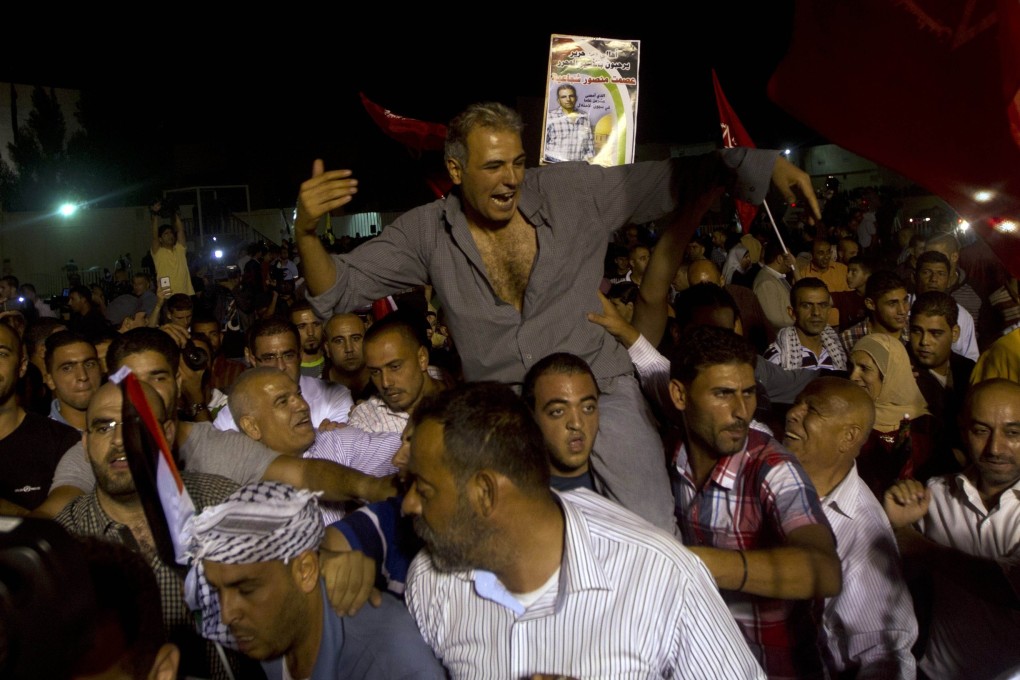Palestinians prisoners released by Israel are greeted by relatives at the Palestinian President's headquarters in the West Bank city of Ramallah. Israel and the Palestinians are now resuming peace talks. Photo: AFP