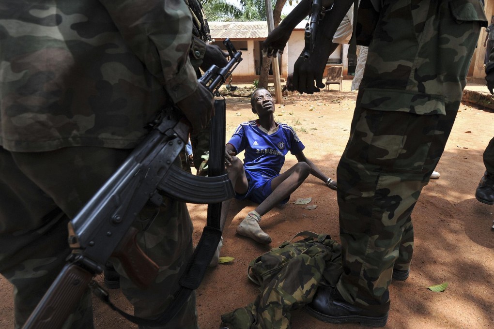 Seleka rebels arrest a looter in the capital, Bangui. Photo: AFP