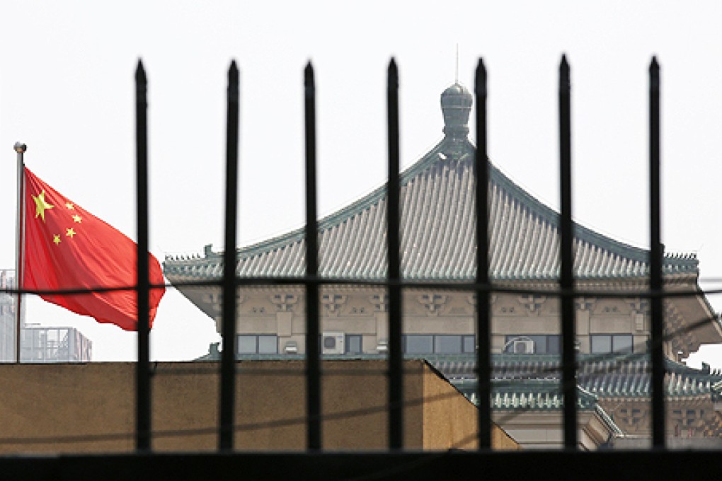 The National Development and Reform Commission, whose headquarters in Beijing can be seen behind the fence, will launch probes into industries that have an impact on the lives of ordinary Chinese citizens. Photo: Reuters
