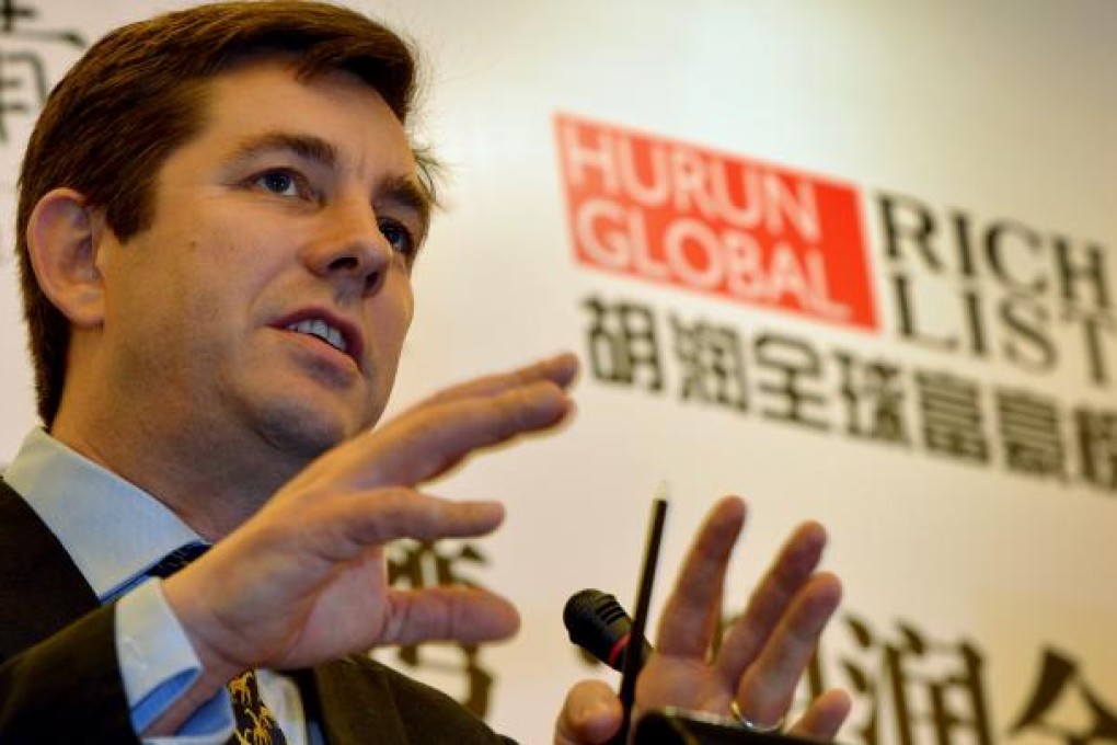 Rupert Hoogewerf, chairman and chief researcher of the Hurun Report, unveils their 'Rich List' at a press conference in Beijing. Photo: AFP