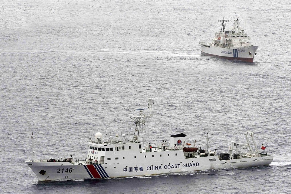 A China Coast Guard vessel (foreground) sails past a Japan Coast Guard ship near the Diaoyu Islands yesterday. Photo: Reuters