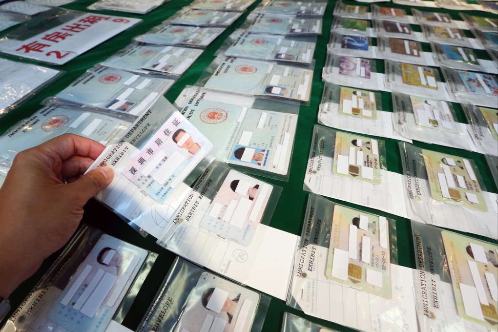 Credit cards and fake identity cards were seized from the forgery syndicate that provided mainland visitors illegal work. Photo: Felix Wong