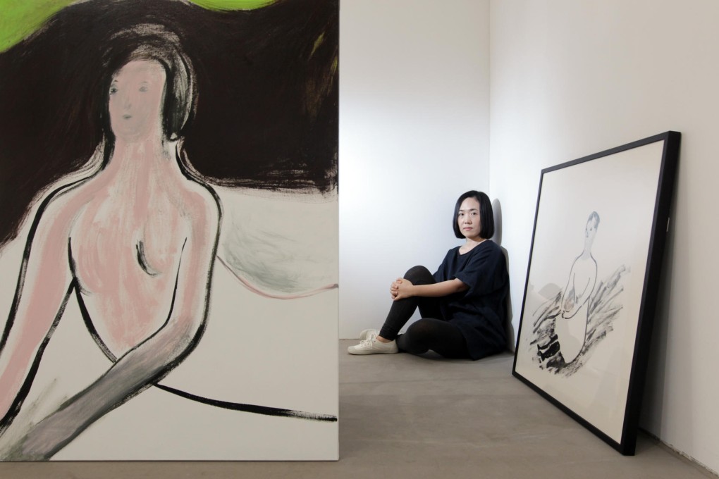 Ngie with two of her works, Pose No 5 (left) and Slipped. Photo: May Tse