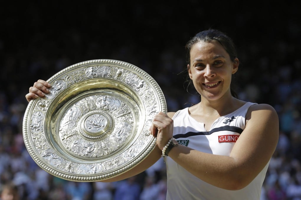 Marion Bartoli smiles as she holds the Wimbledon trophy. Photo: AP