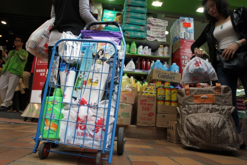 People buying daily household products such as shampoo in a pharmacy in Fanling. Photo: Felix Wong
