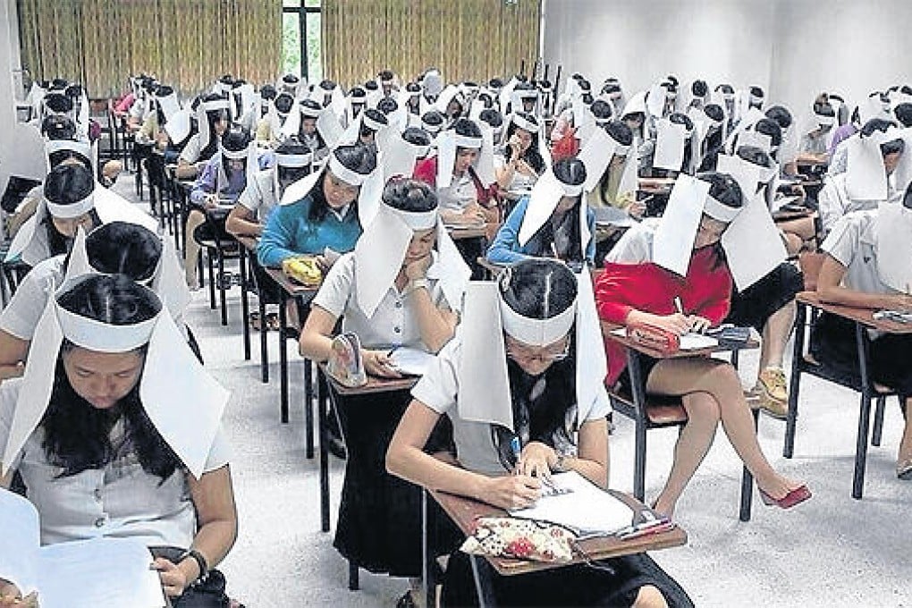 Students wear paper anti-cheating headgear. Photo: SCMP
