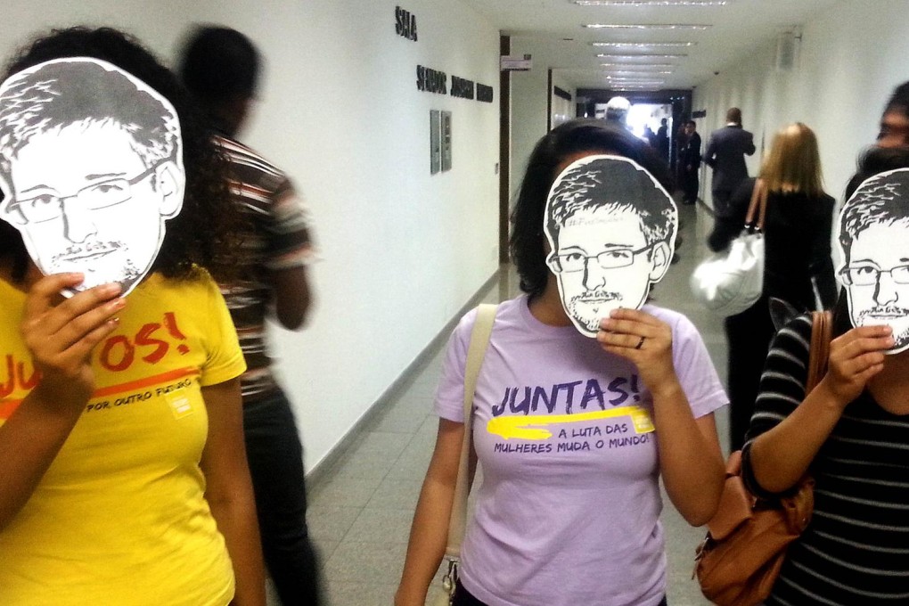 Brazilian activists with Edward Snowden masks. Photo: AFP